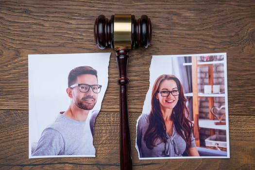 Family Photo Torn In Half Near Judge Gavel On The Wooden Desk