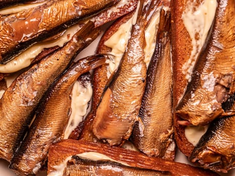 Sandwiches with sprats on bread. Food photo. Place for text. Background image.
