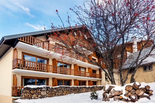 Les deux Alpes, Alps, France, January 2017 Piles of logs in front of traditional alpine wooden house or hut. Popular ski and winter sport destination