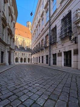 Historic Vienna, cobblestone street called Metastasiogasse with Minoritenkirche