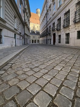 Historic Vienna, cobblestone street called Metastasiogasse with Minoritenkirche