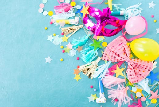 Cheerful decorations and party garlands on a blue background