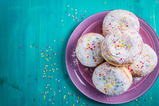 Carnival powdered sugar raised donuts - German Berliner donuts, Krapfen filled with jam