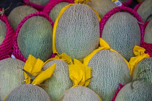 Pile of fresh melons for sale in a fruit and vegetable shop on the street in Zigong, China