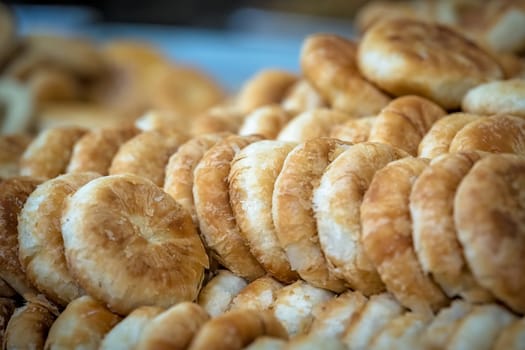 Large plate with delicious small sweet bunsand cakes on sale in bakery in China