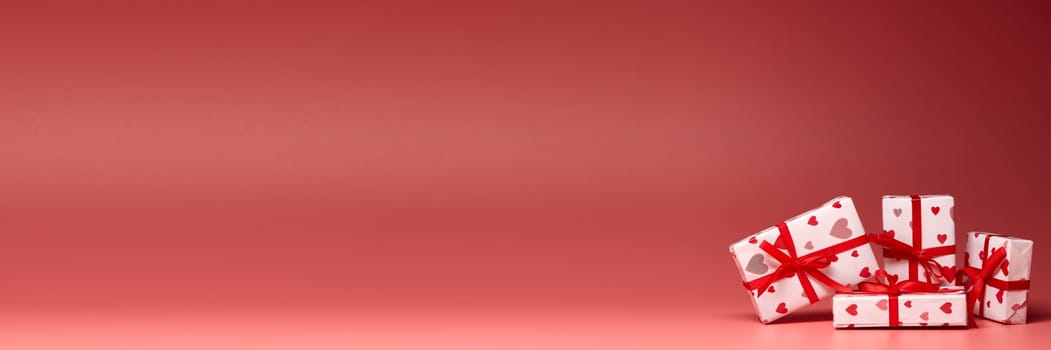 Gift boxes on pink background with copy space. Valentine's Day. Mother's day, wedding, women's day. Extra wide panorama banner background