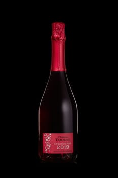 St.Petersburg, Russia - December 2019  - Bottle of semi-dry pink young sparkling wine Chateau Tamagne Krasnostop 2019 on black background.