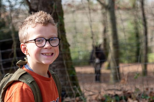 a portrait of young boy with glasses