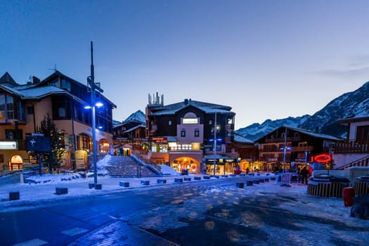 Les deux Alpes, Alps, France, January 2017 Nightlife in alpine village with traditional wooden houses, shops and restaurants. Popular ski destination
