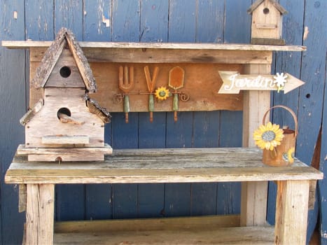 Outdoor wood table with decorations against blue wall