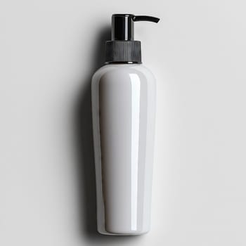 Minimalist white plastic bottle with a black pump dispenser, designed for liquid soap, lotion, or shampoo, placed against a neutral background.