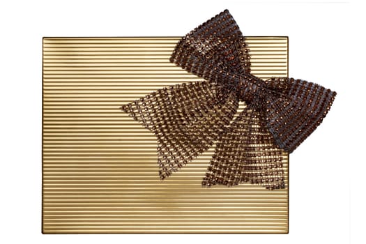Ribbon bow card template. Closeup of a decorative festive golden shiny glitter ribbon bow with rhinestones placed on a golden background. Wedding, birthday, aniversary, party, invitation card.