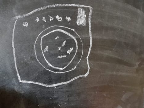 Drawing of a wash machine on a blackboard. Drawing made by child.