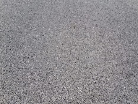 Light gray asphalt for pavement. The surface of the asphalt is smooth. Tarmac construction material. Good for neutral backgrounds.