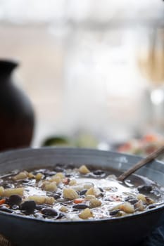 Black bean and potato soup in blue bowl