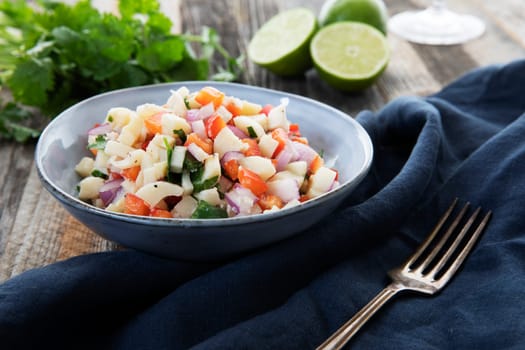 Vegan salad with hearts of palm, red onion, pepper, cilantro and lime dressing.