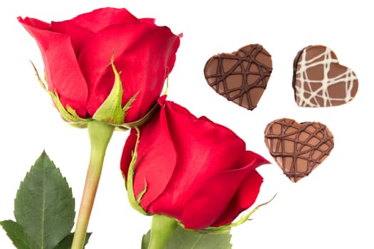 Bright red roses and heart shaped chocolates isolated on a white background