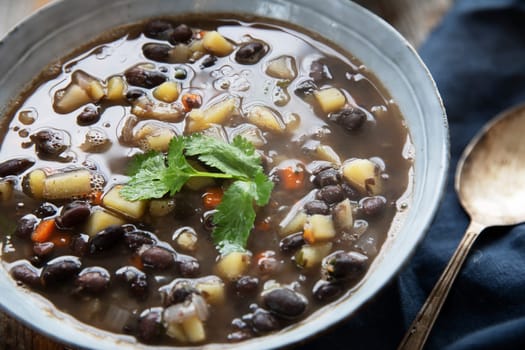Black bean and potato soup in blue bowl