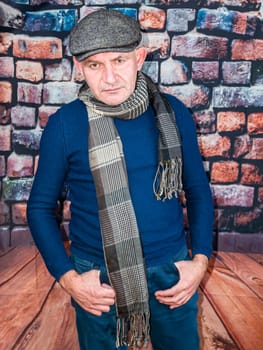 A man in a cap against a brick wall. People. Place for text. Background image. Photo model. Fashion.