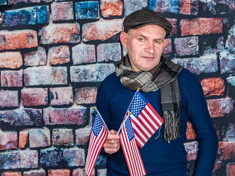 A man with an American flag in his hand on Independence Day. Independence Day of America. Elections. Patriot. People. Place for text. Background image. Photo model.