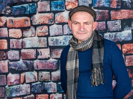 A man in a cap against a brick wall. People. Place for text. Background image. Photo model. Fashion.