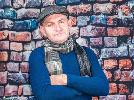 A man in a cap against a brick wall. People. Place for text. Background image. Photo model. Fashion.