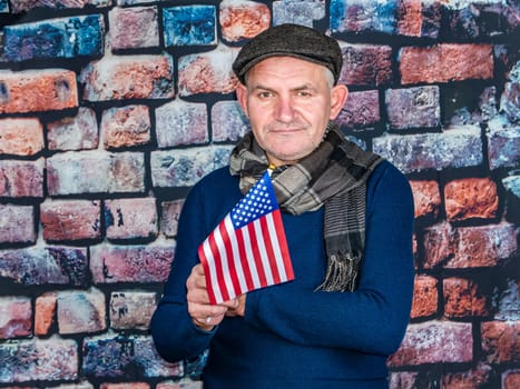 A man with an American flag in his hand on Independence Day. Independence Day of America. Elections. Patriot. People. Place for text. Background image. Photo model.