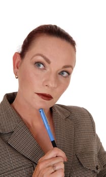 A serious looking business woman holding her blue pen.looking away and thinking hard, isolated for white background.