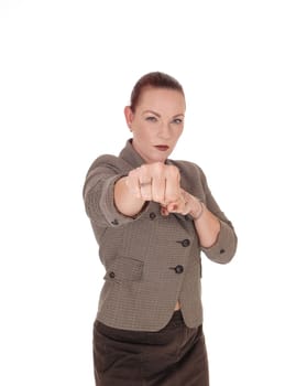 A middle age businesswoman standing and punching with her fist.is very angry, isolated for white background.