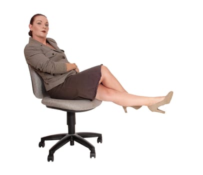 A gorgeous business woman sitting all dressed up on a chair and.and resting after a long day, isolated for white background.