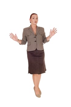 A serious looking woman in a brown jacket standing and holding her.hands up, I don't know anything, isolated for white background.
