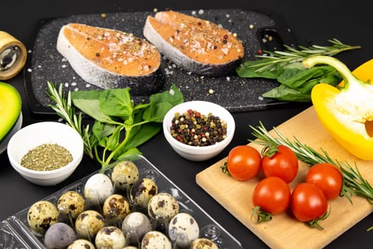 A set of healthy balanced super food, fresh salmon, vegetables, cereals on a black background. Top view, flat lay with copy space