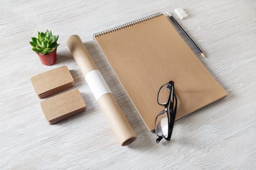 Blank retro stationery set on light wooden background. Corporate identity template. Responsive design mockup.
