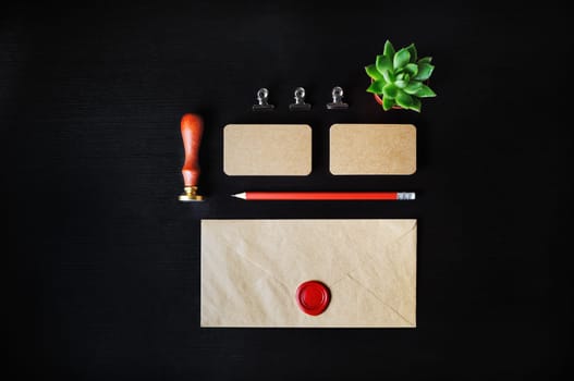Vintage stationery mock up. Blank corporate identity template on black wooden background. Responsive design mockup. Flat lay.