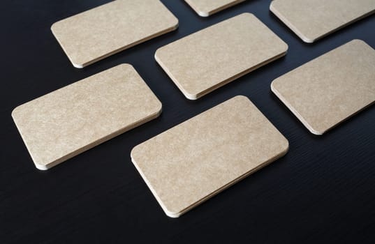 Vintage business cards mockup on black wood table background. Template for branding ID.