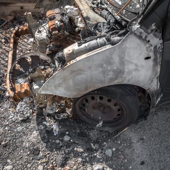 Car destroyed with busted engine. Abandoned car.