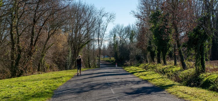 sporty woman on the small road at winter season