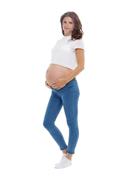 Young pregnant woman is standing isolated on white background.