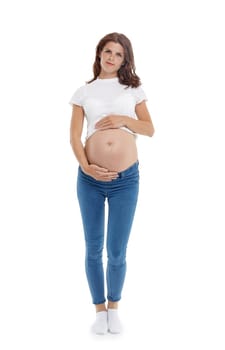 Young pregnant woman is standing isolated on white background.