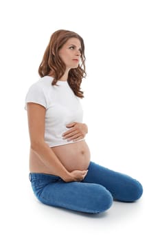 Young pregnant woman is sitting isolated on white background.