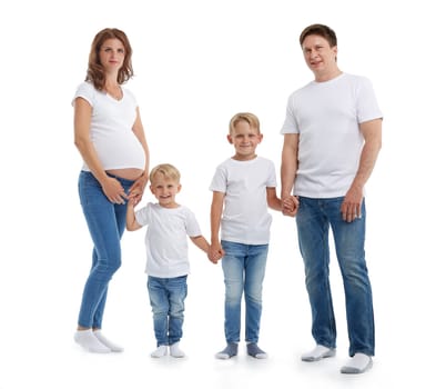 Happy parents: pregnant mother and father with lovely two sons are stand holding hands and smiling, isolated on a white background. Happy friendly family. Concept of people and family