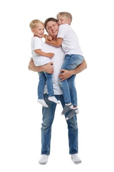 Friendly family. Young man holding two children stands isolated on a white background. Happy parent. Father with two son. Concept of people, parenting and family