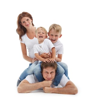 Friendly family. Young pregnant woman with two children and her husband are sitting, isolated on a white background.  Happy parents. Pregnant mother and father with two sons. Concept of people and family