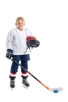 Junior ice hockey player . Child (boy) is hockey player in uniform with full equipment isolated on white background. Concept of children's sport, winter sport, healthy lifestyle.