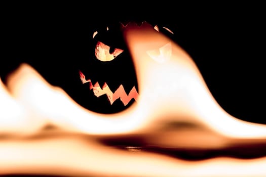 Big helloween autumn symbol with mad face, glowing eyes, mouth and teeth. Scary hot nightmare horror with evil smile at october 31st.
