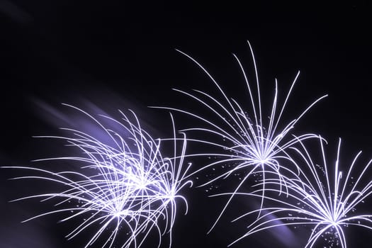 Premium entertainment magic star firework at e.g. New Years Eve or Independence Day party celebration. Black dark night background.