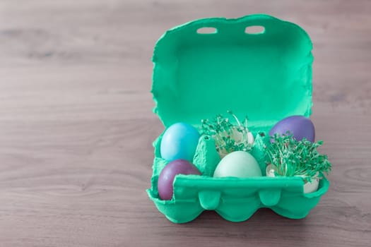 Beautiful decoration easternest basket with painted eggshells for celebration. Lovely traditional gift design on wooden background.