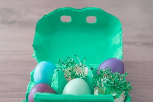 Beautiful decoration easternest basket with painted eggshells for celebration. Lovely traditional gift design on wooden background.