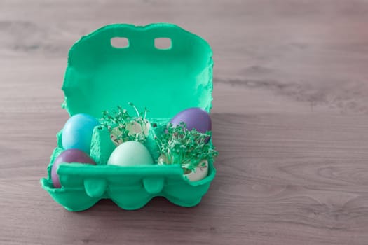 Beautiful decoration easternest basket with painted eggshells for celebration. Lovely traditional gift design on wooden background.