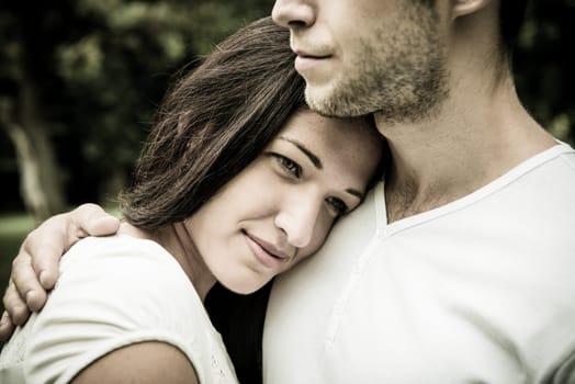 Romantic moments - young couple together, woman's head laid on men's shoulder of man